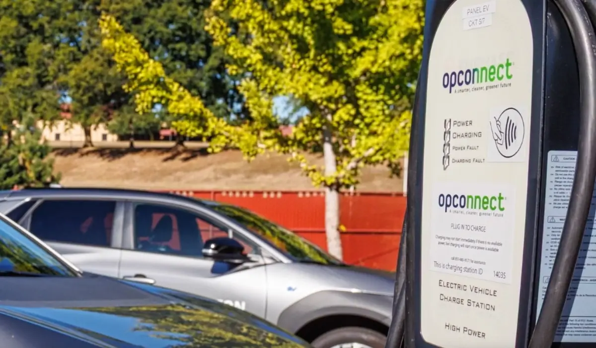 OpConnect electric vehicle charging station beside parked electric vehicles.