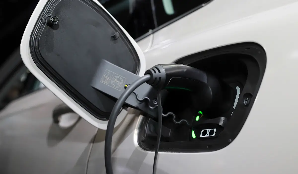 Electric vehicle charging cable connected to an EV charging port